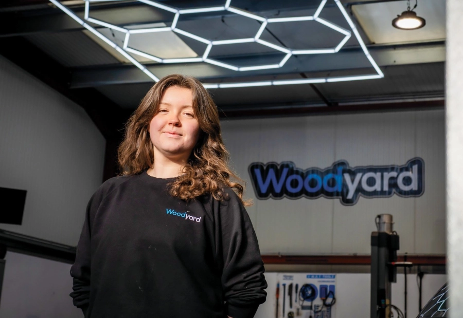 Apprentice stood by Woodyard sign