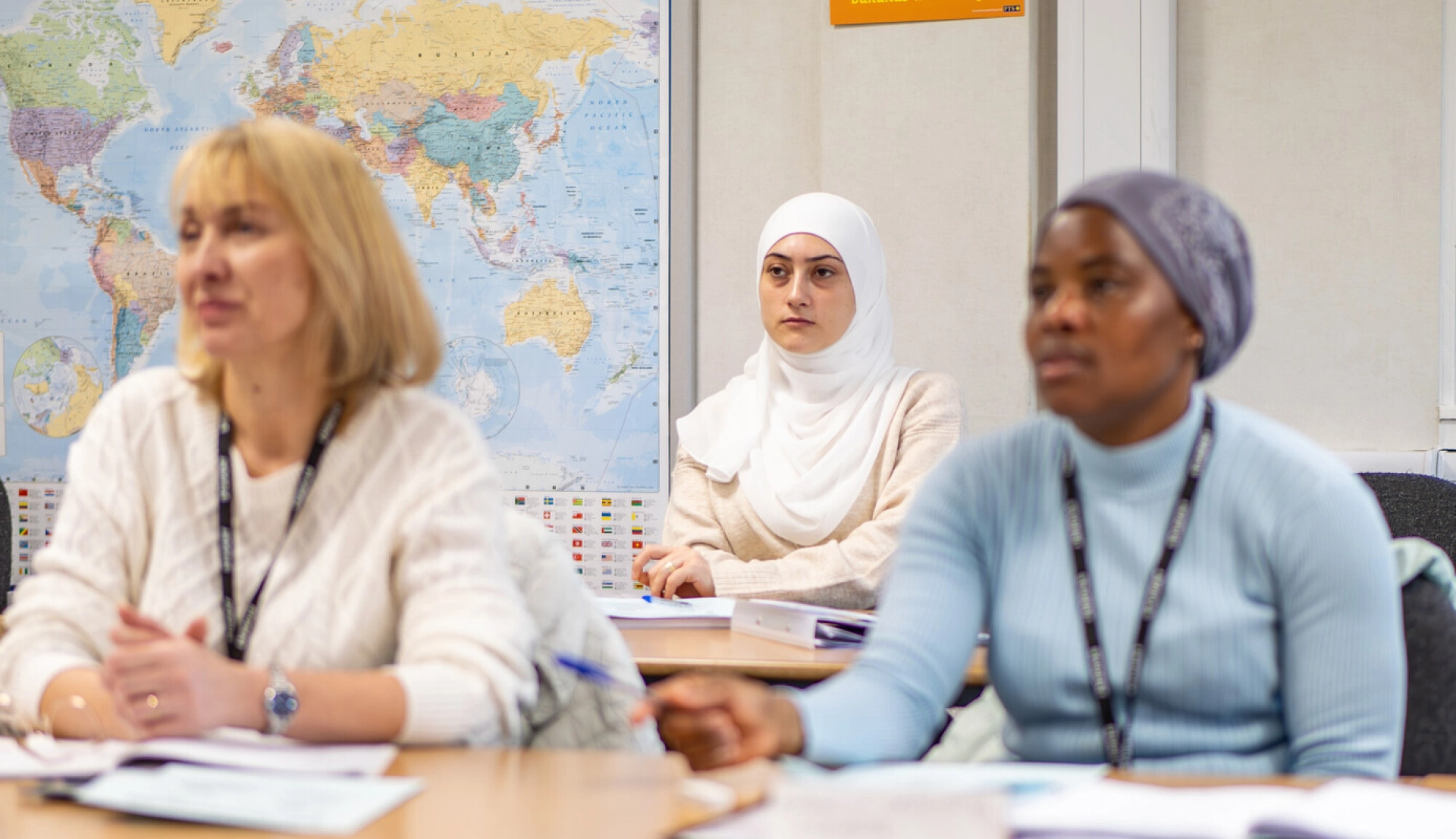 3 students on an ESOL course learning in the class room
