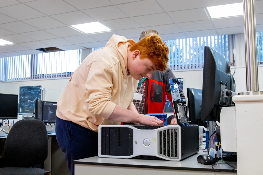 Student working on desktop pc in classroom