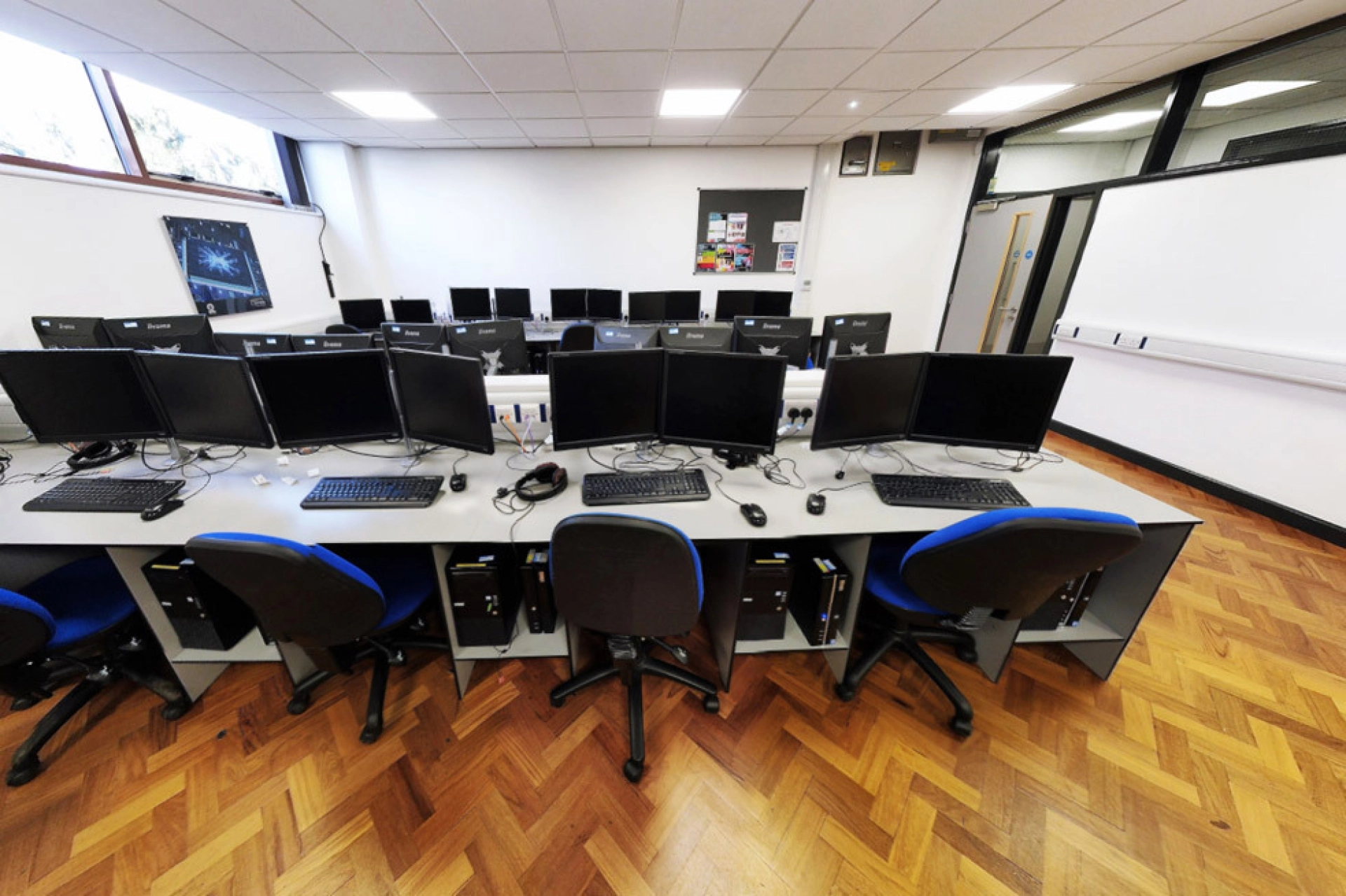 Computer suite equipped with computers, screens and desks