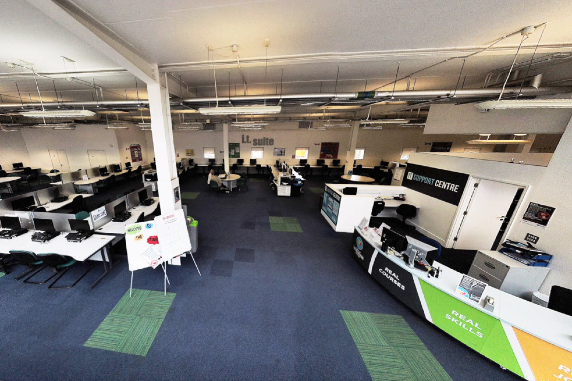 IT suite with lots of desks, computers and chairs