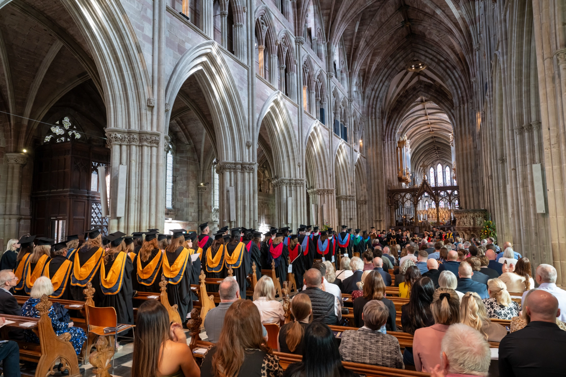 Group of graduands sitting in a cathedral 1