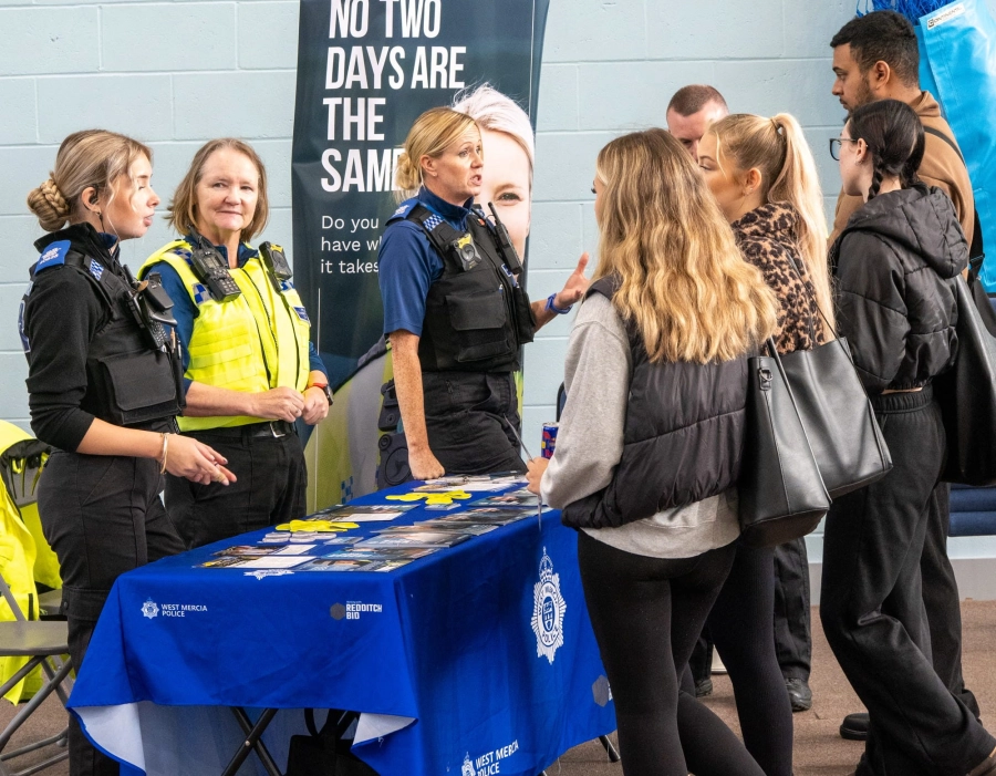 Group of students having a conversation with police representatives