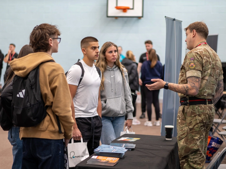 Students talking to army member representitive