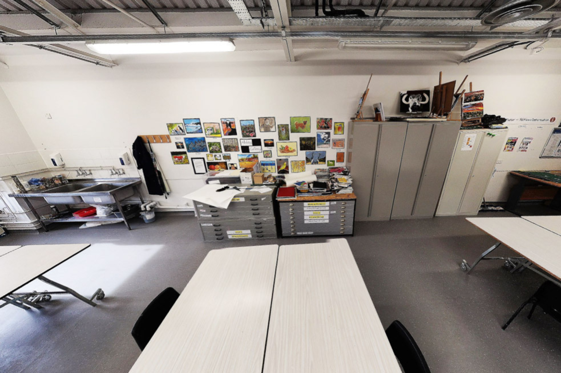 Art and design classroom with tables and artworks