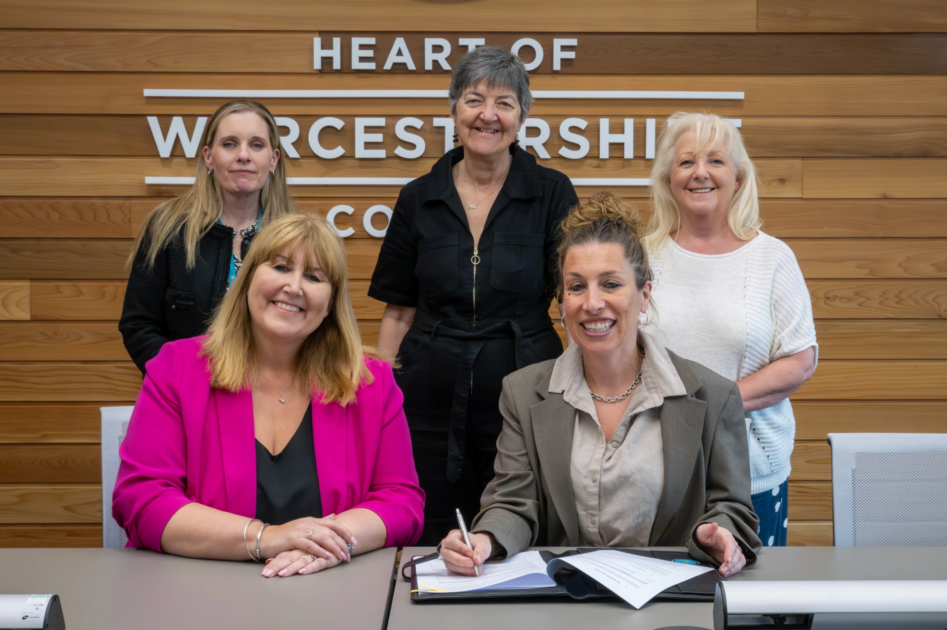 Scala staff and HoW College ELT members signing an agreement