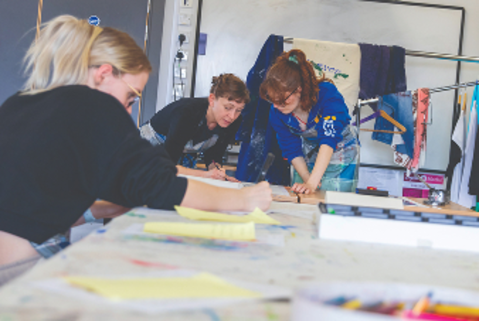 students and teacher drawing