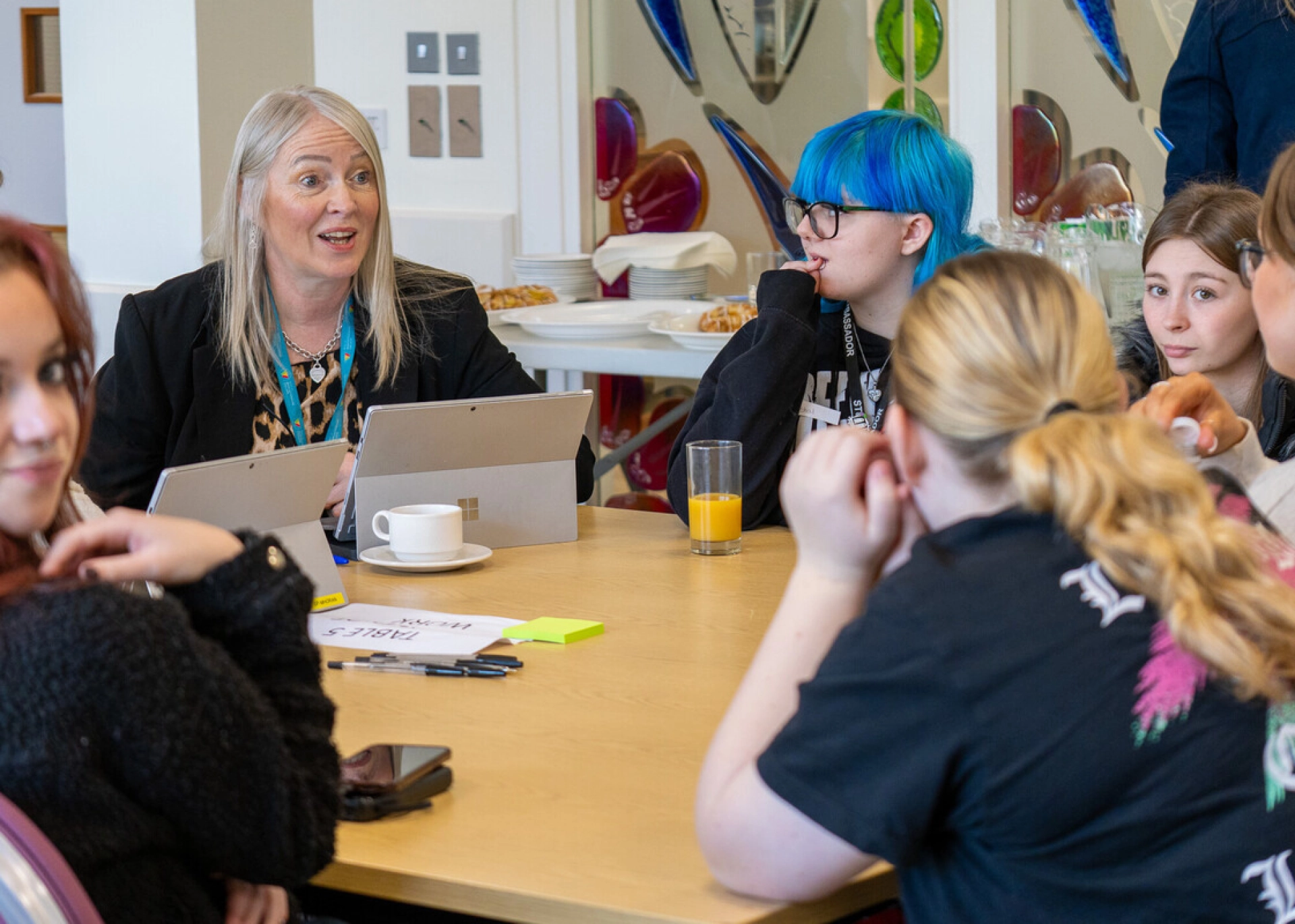 College Students speaking to a member of staff